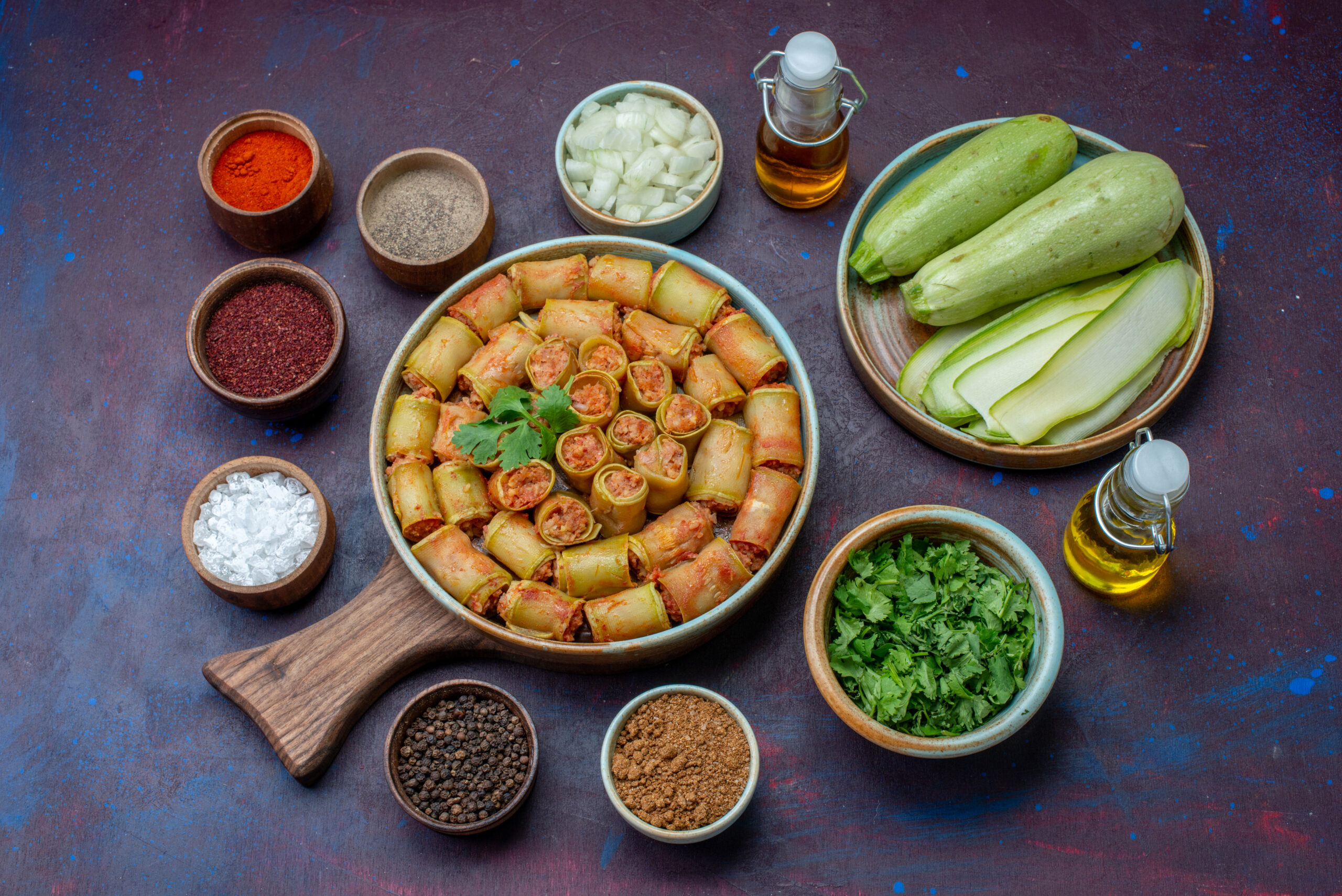 top-view-seasonings-inside-pots-salt-pepper-with-fresh-squashes-meat-rolls-dark-purple-surface